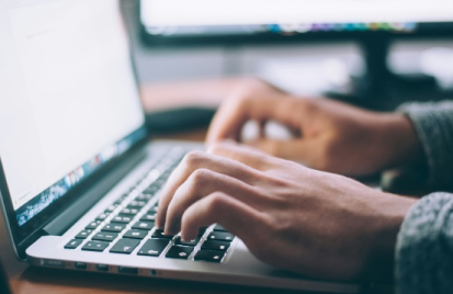 person typing on a laptop